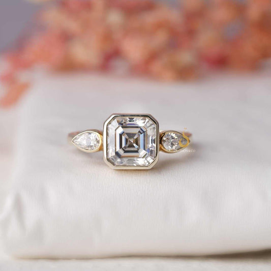 Three Stone Bezel Set Asscher and Pear Shape Moissanite Ring First